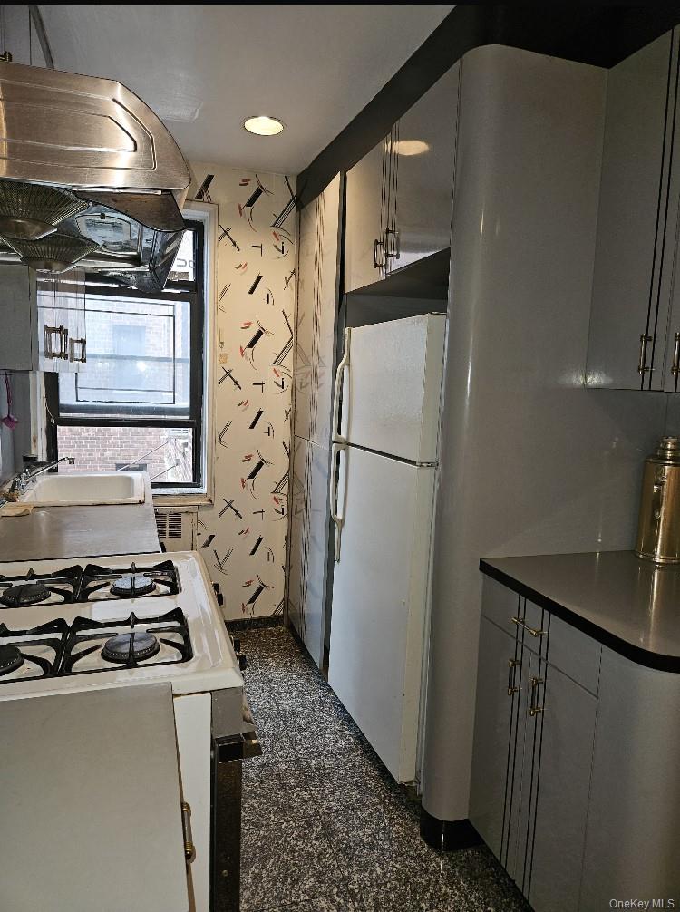 102-18 64th Avenue, Unit 2X Queens, NY 11375 - Photo 13 of 17 a kitchen with a refrigerator and a stove
