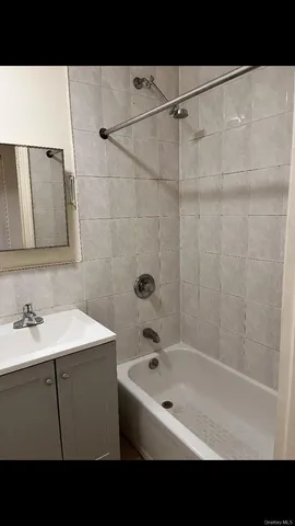 a bathroom with a sink a mirror and a bathtub