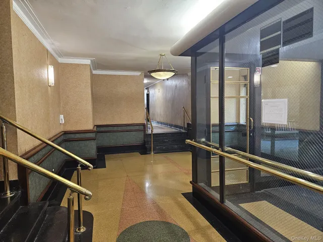 a lobby with windows and stairs