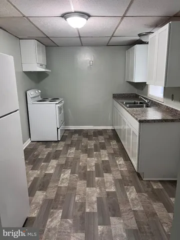 a kitchen with a sink and a stove top oven