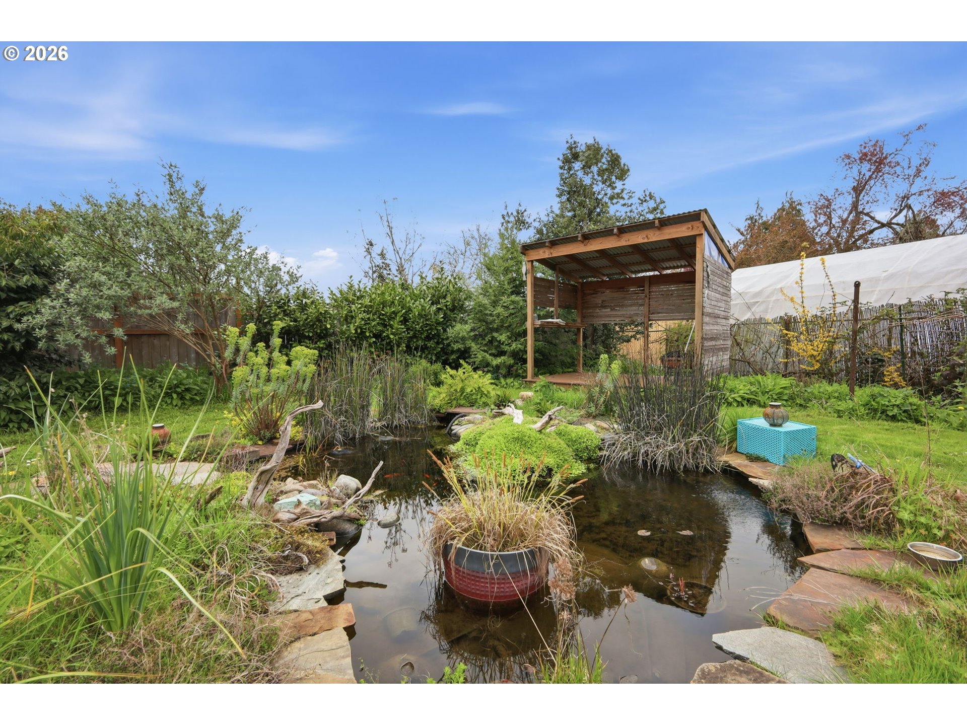 710 South 1st Street Cottage Grove, OR 97424 - Photo 41 of 46 a backyard of a house with table and chairs plants and large trees