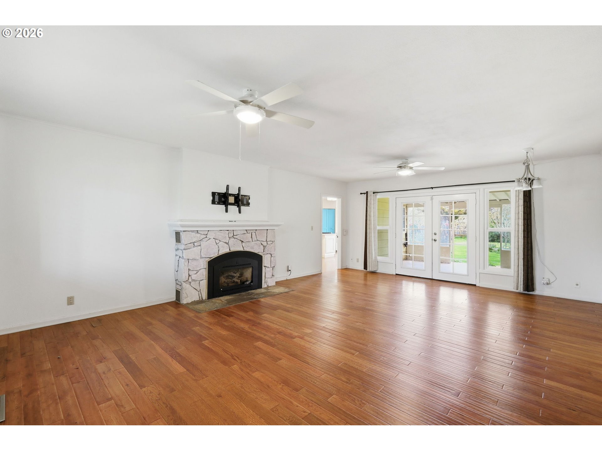 710 South 1st Street Cottage Grove, OR 97424 - Photo 5 of 46 a view of an empty room with chandelier fan and fire place
