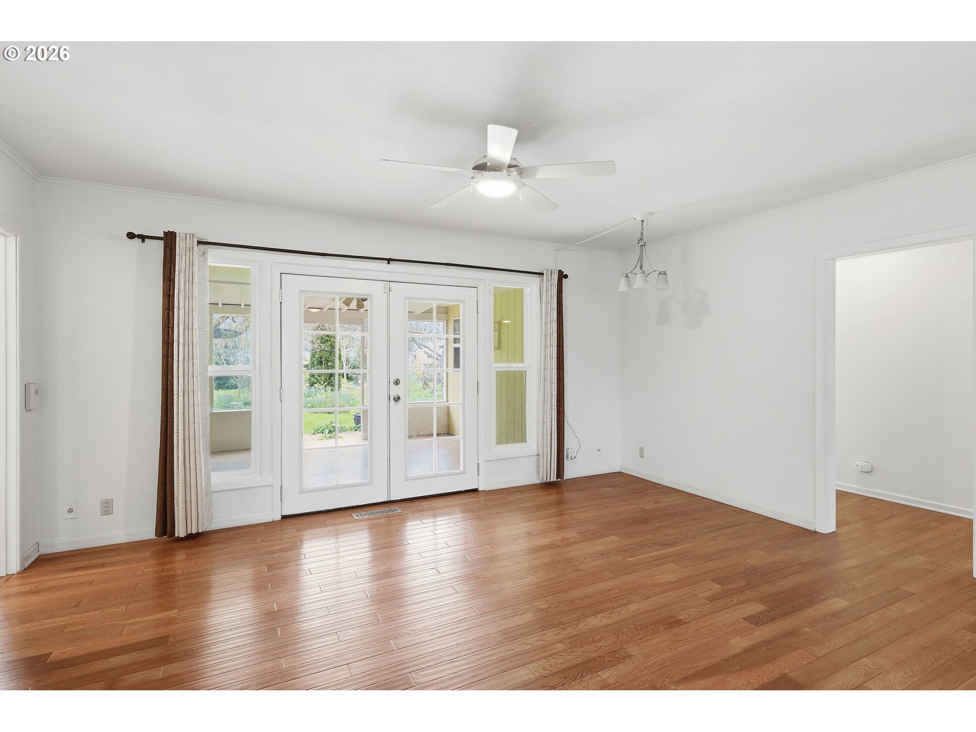 710 South 1st Street Cottage Grove, OR 97424 - Photo 6 of 46 a view of an empty room with wooden floor and a window