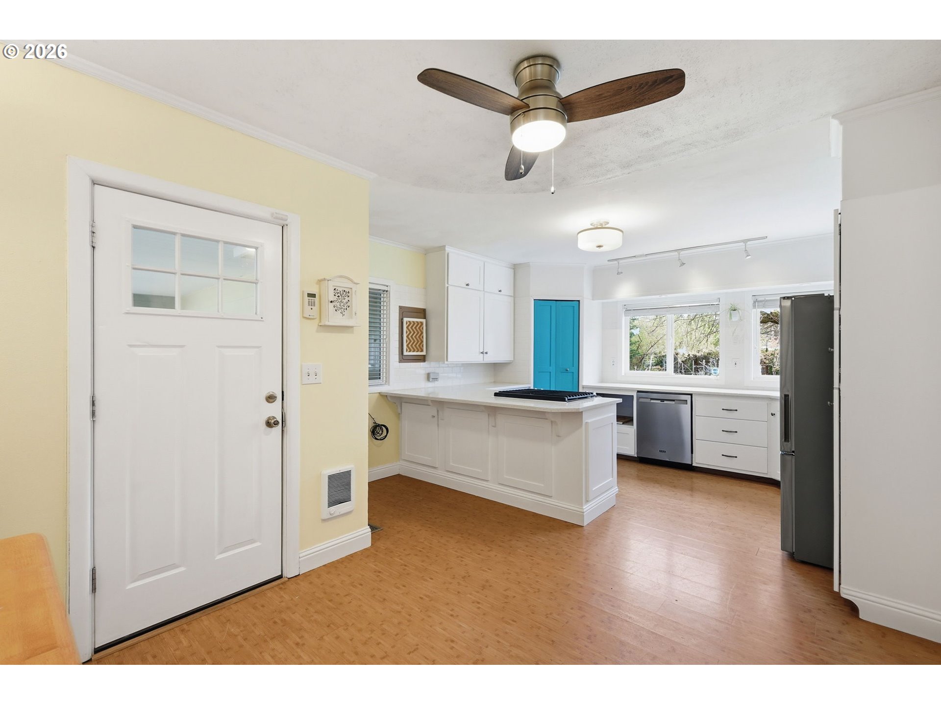 710 South 1st Street Cottage Grove, OR 97424 - Photo 7 of 46 a view of a kitchen with kitchen island stainless steel appliances wooden floor and window