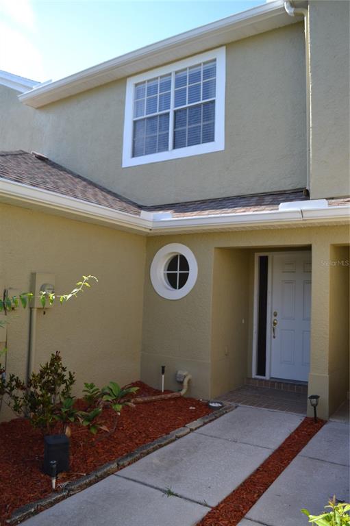 11235 Kapok Grand Circle Madeira Beach, FL 33708 - Photo 31 of 34 a front view of a house