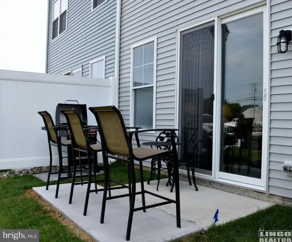 a view of a patio with table and chairs and potted plants