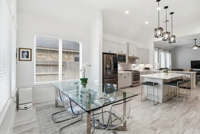a view of a workspace with furniture and window