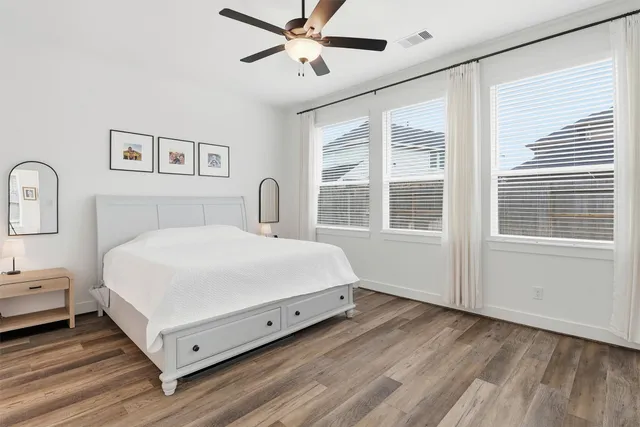 a dining room with furniture and potted plants