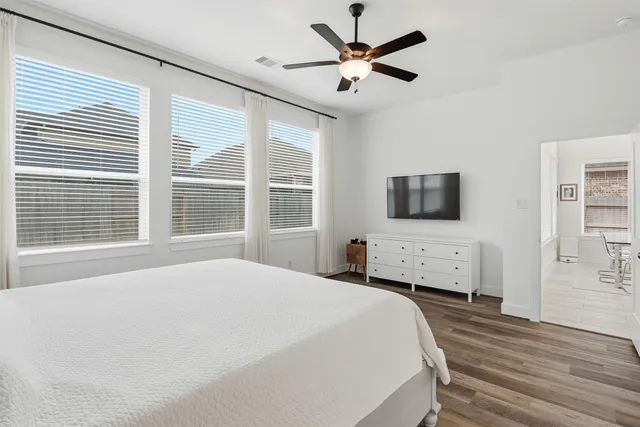 a bedroom with a large bed and a window