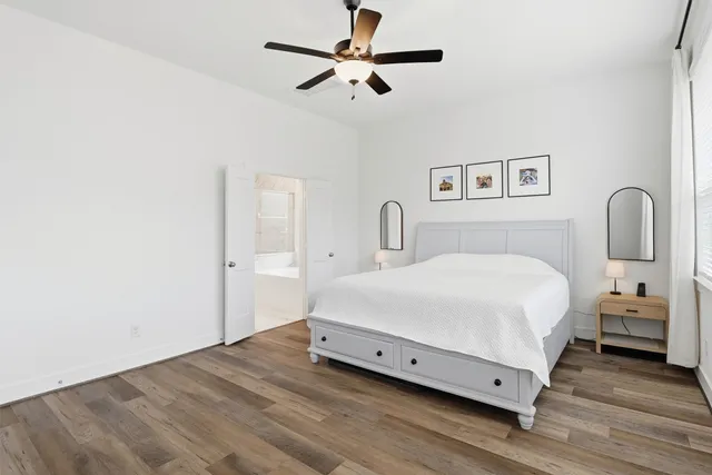 a bedroom with a bed tv and window