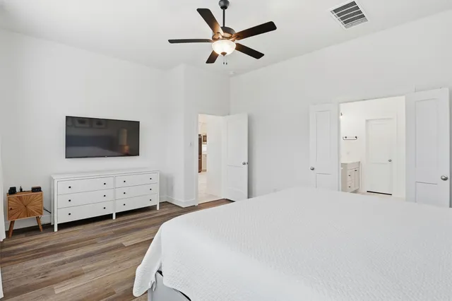 a bedroom with a bed and a chandelier
