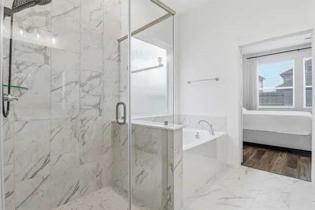 a bathroom with a bathtub and a shower