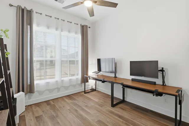 a view of a bedroom with furniture and wooden floor