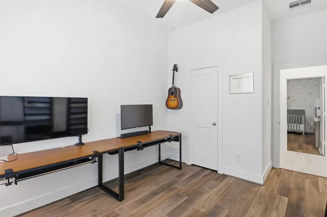 a view of a workspace with furniture and a window