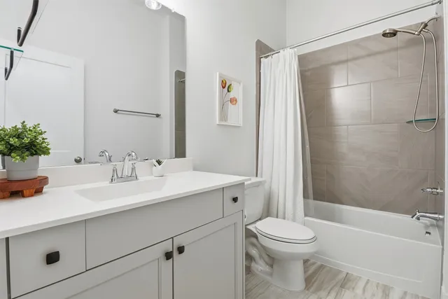 a spacious bathroom with a sink a vanity and a toilet