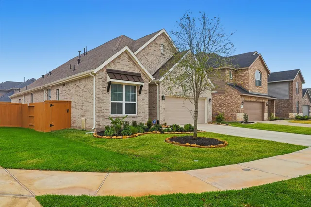 a view of an house with backyard space and balcony