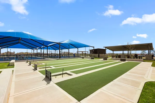 a swimming pool with outdoor seating yard and barbeque oven