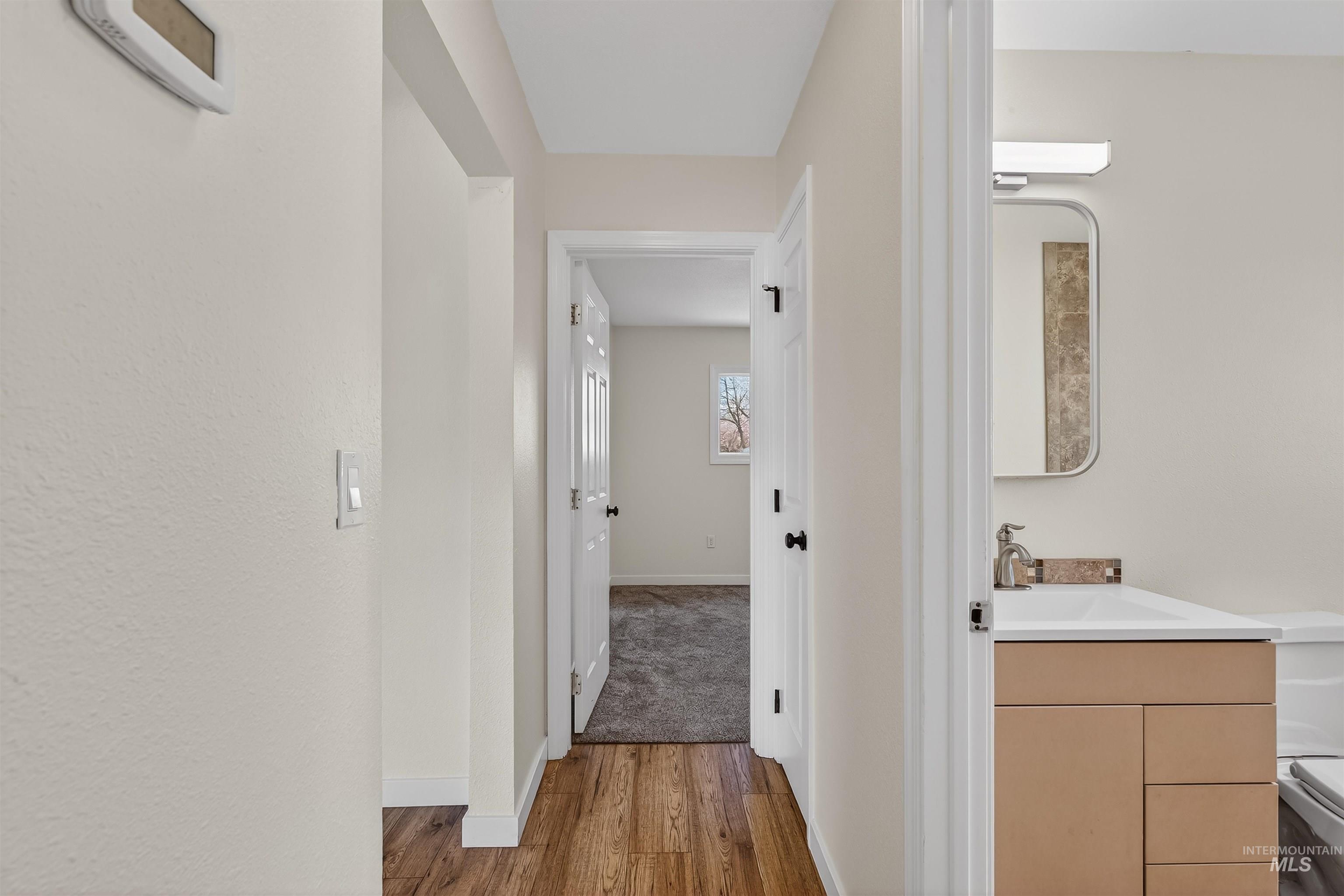 1519 17th Street Lewiston, ID 83501 - Photo 15 of 39 Hallway with baseboards and light wood finished floors