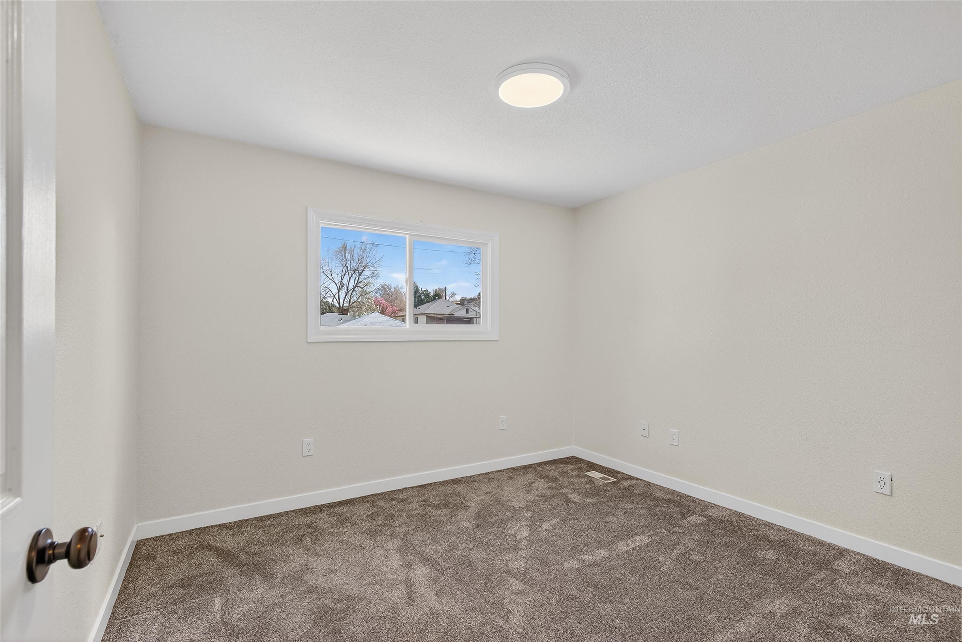 1519 17th Street Lewiston, ID 83501 - Photo 20 of 39 Empty room with baseboards and dark carpet