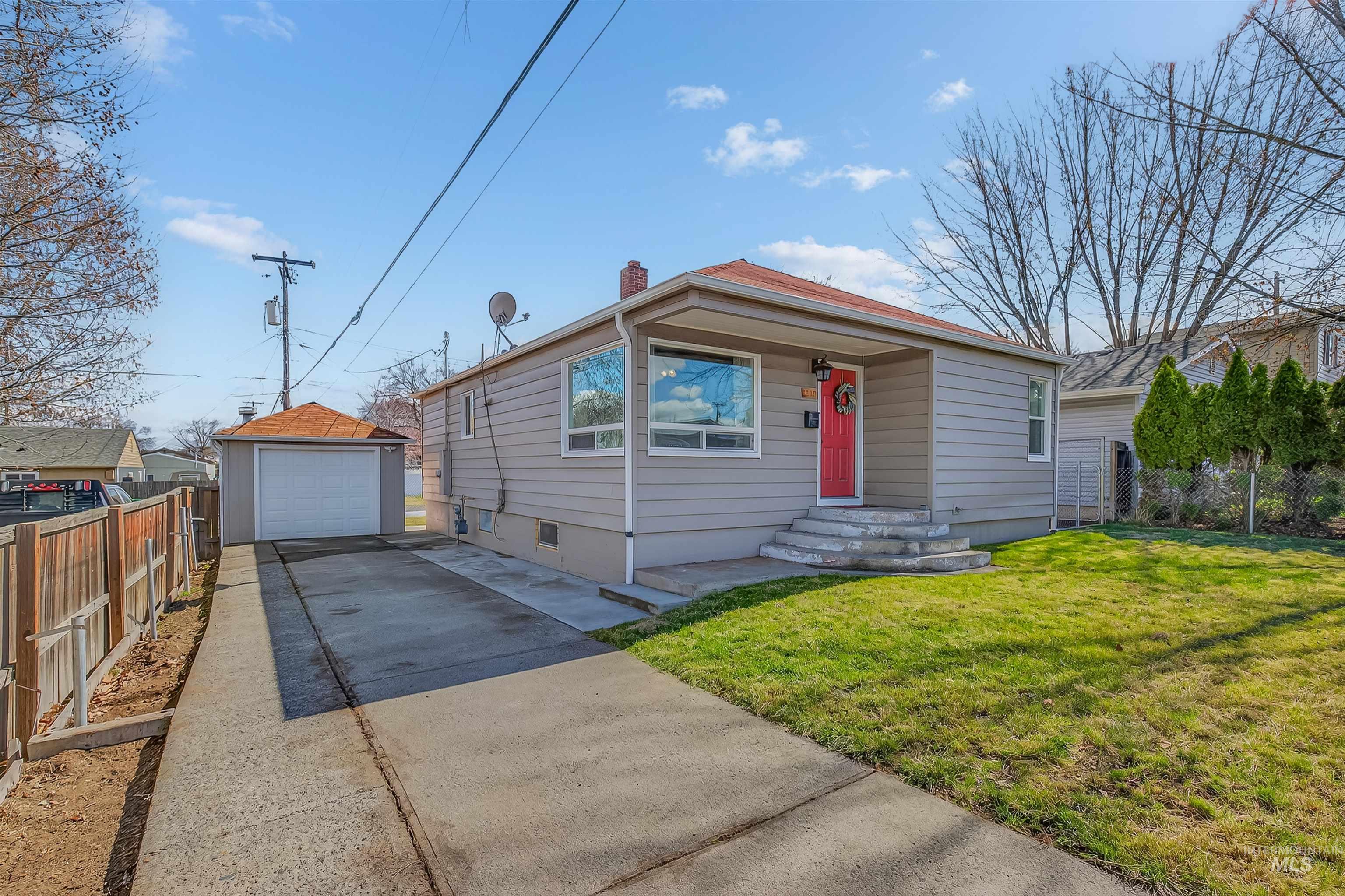 1519 17th Street Lewiston, ID 83501 - Photo 33 of 39 View of front of house with an outbuilding, a detached garage, driveway, and a chimney