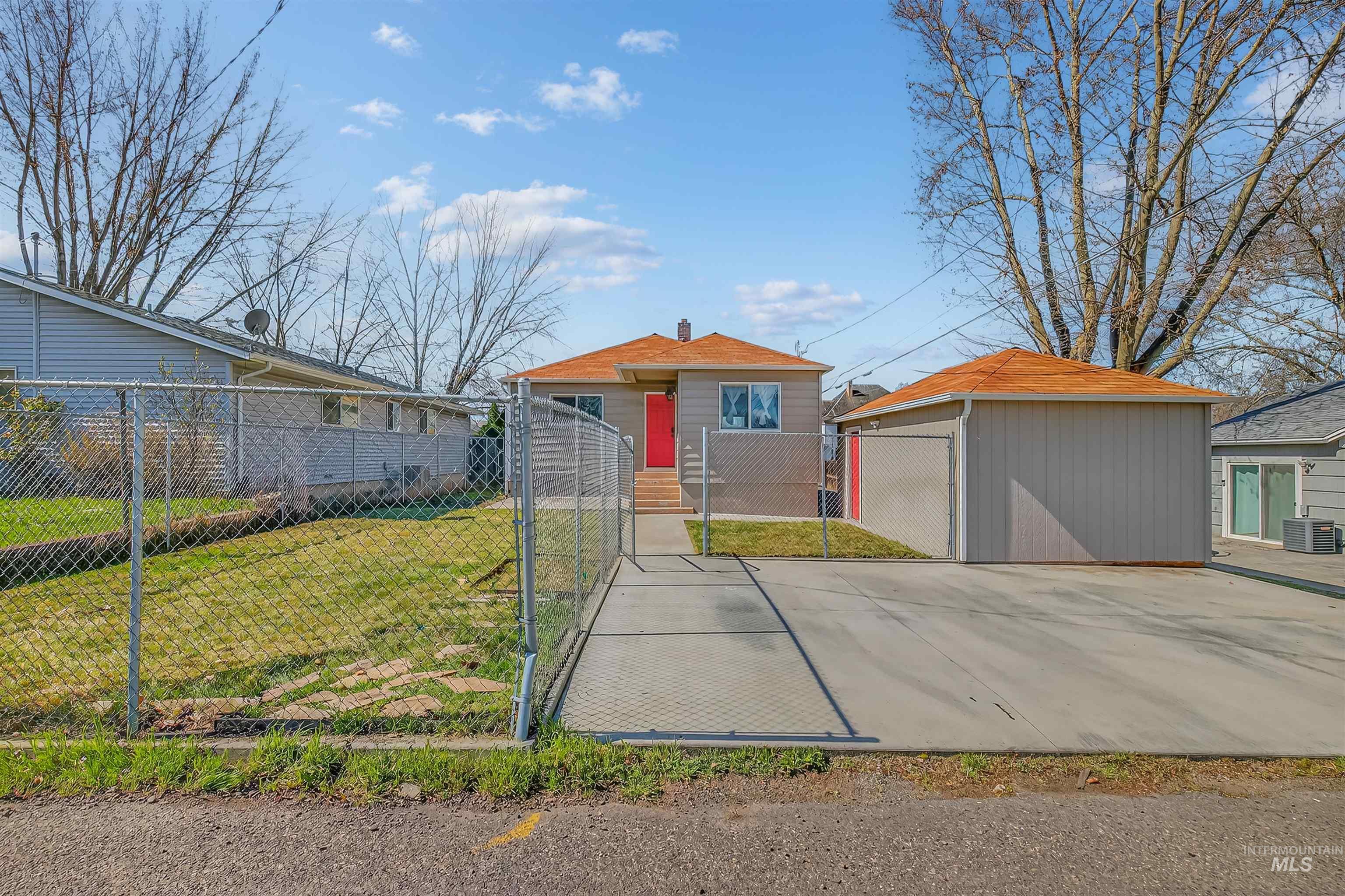 1519 17th Street Lewiston, ID 83501 - Photo 34 of 39 View of front of home featuring a fenced front yard, a gate, and an outdoor structure