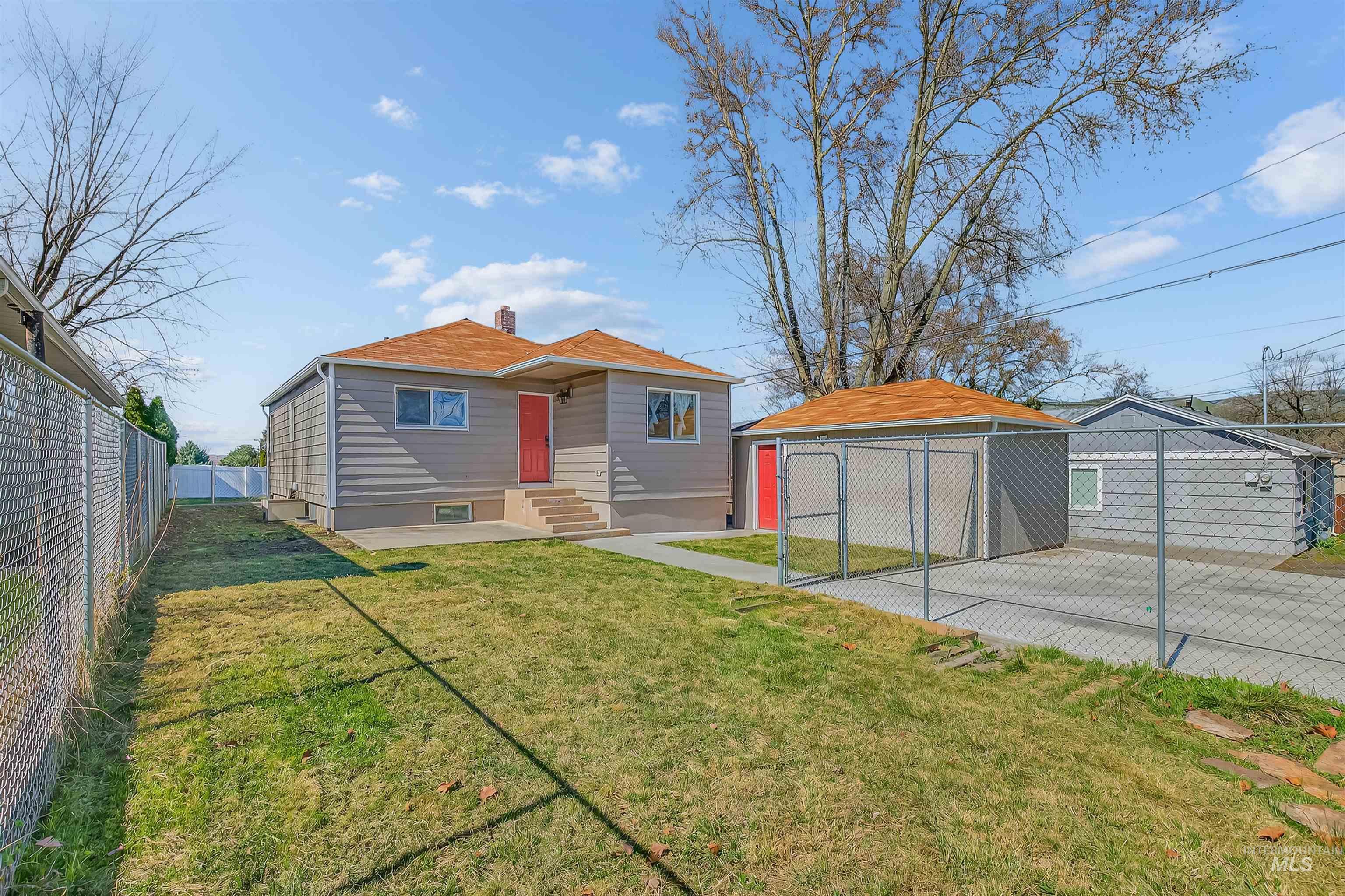 1519 17th Street Lewiston, ID 83501 - Photo 39 of 39 Rear view of property featuring a chimney, an outbuilding, a detached garage, and entry steps