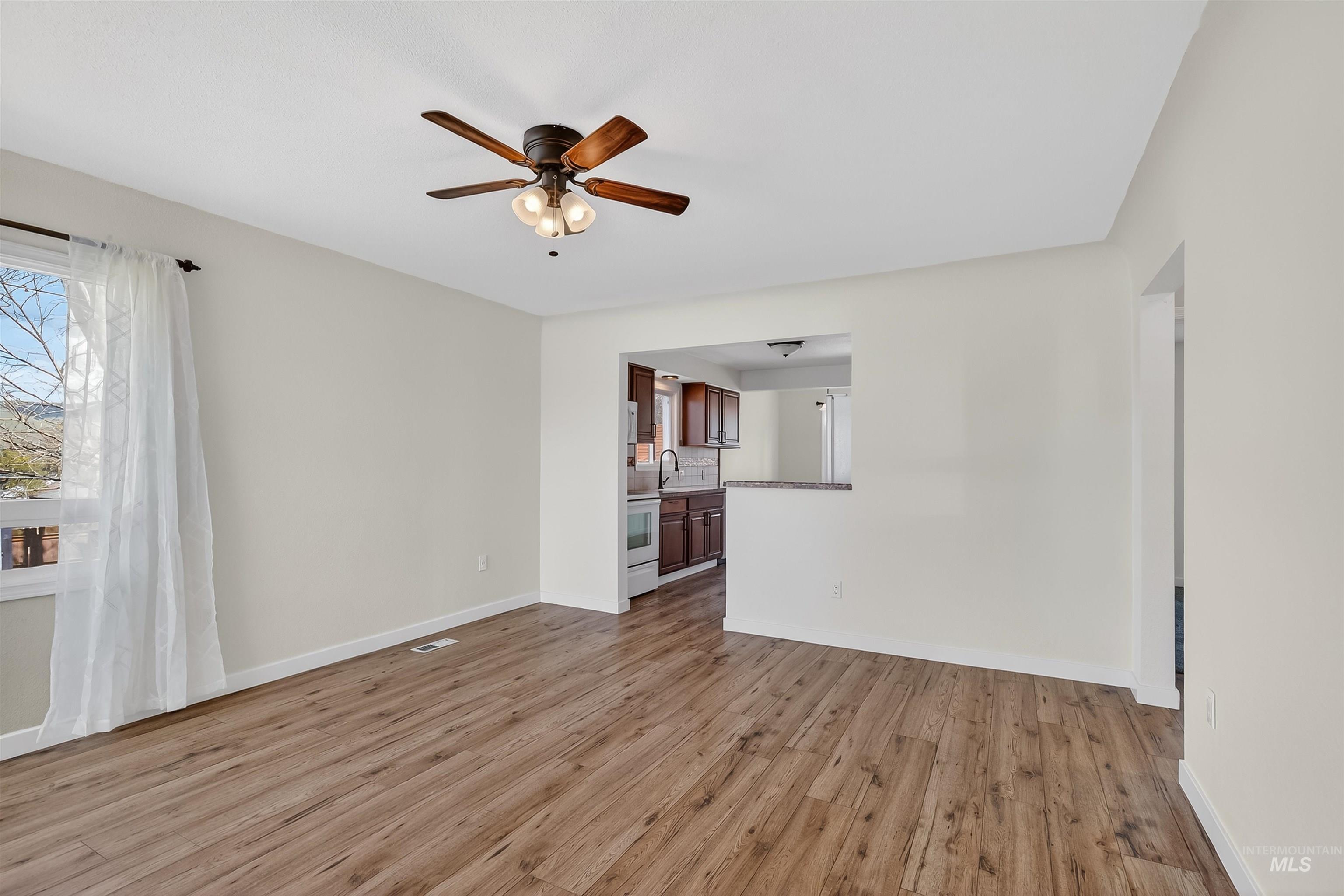 1519 17th Street Lewiston, ID 83501 - Photo 8 of 39 Unfurnished living room with light wood-style floors and ceiling fan
