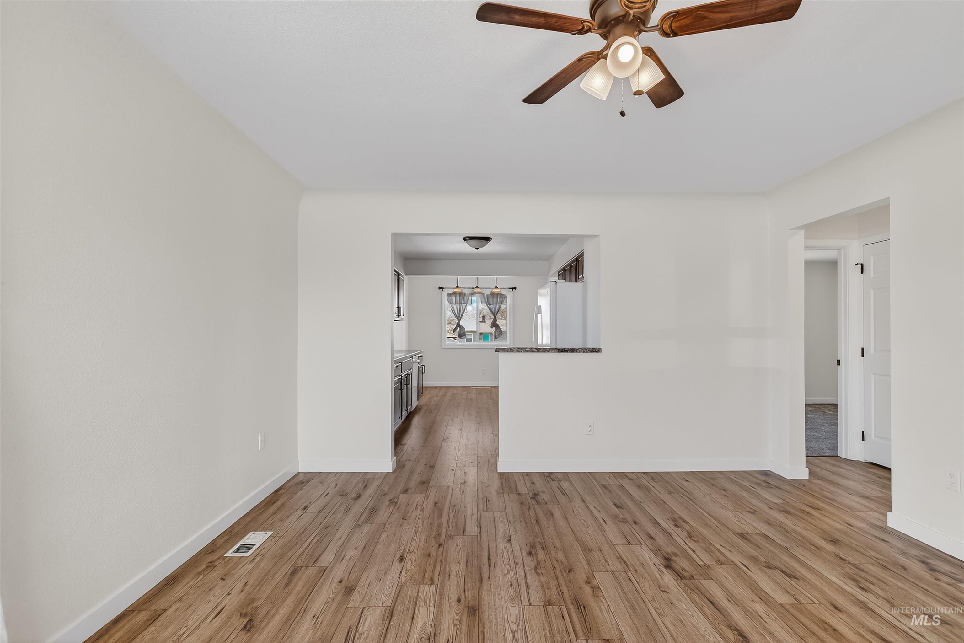 1519 17th Street Lewiston, ID 83501 - Photo 9 of 39 Unfurnished living room featuring light wood-style flooring and a ceiling fan
