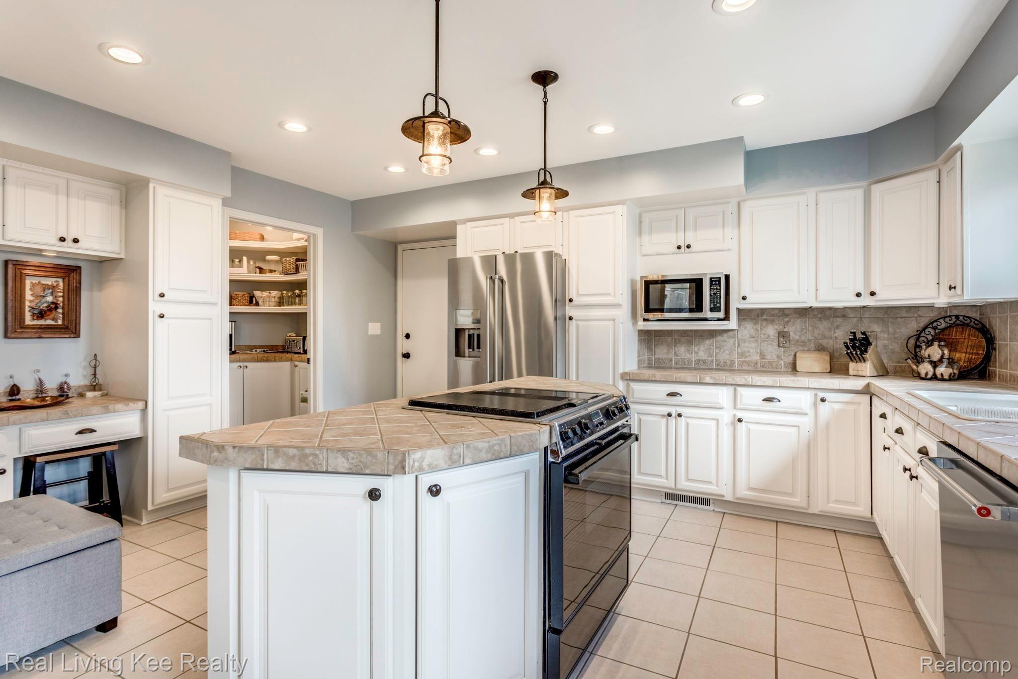 5775 McIntyre Road North Street, MI 48049 - Photo 20 of 65 5775 McIntyre Rd kitchen island nice butler pantry possible laundry and door to garage.JPG