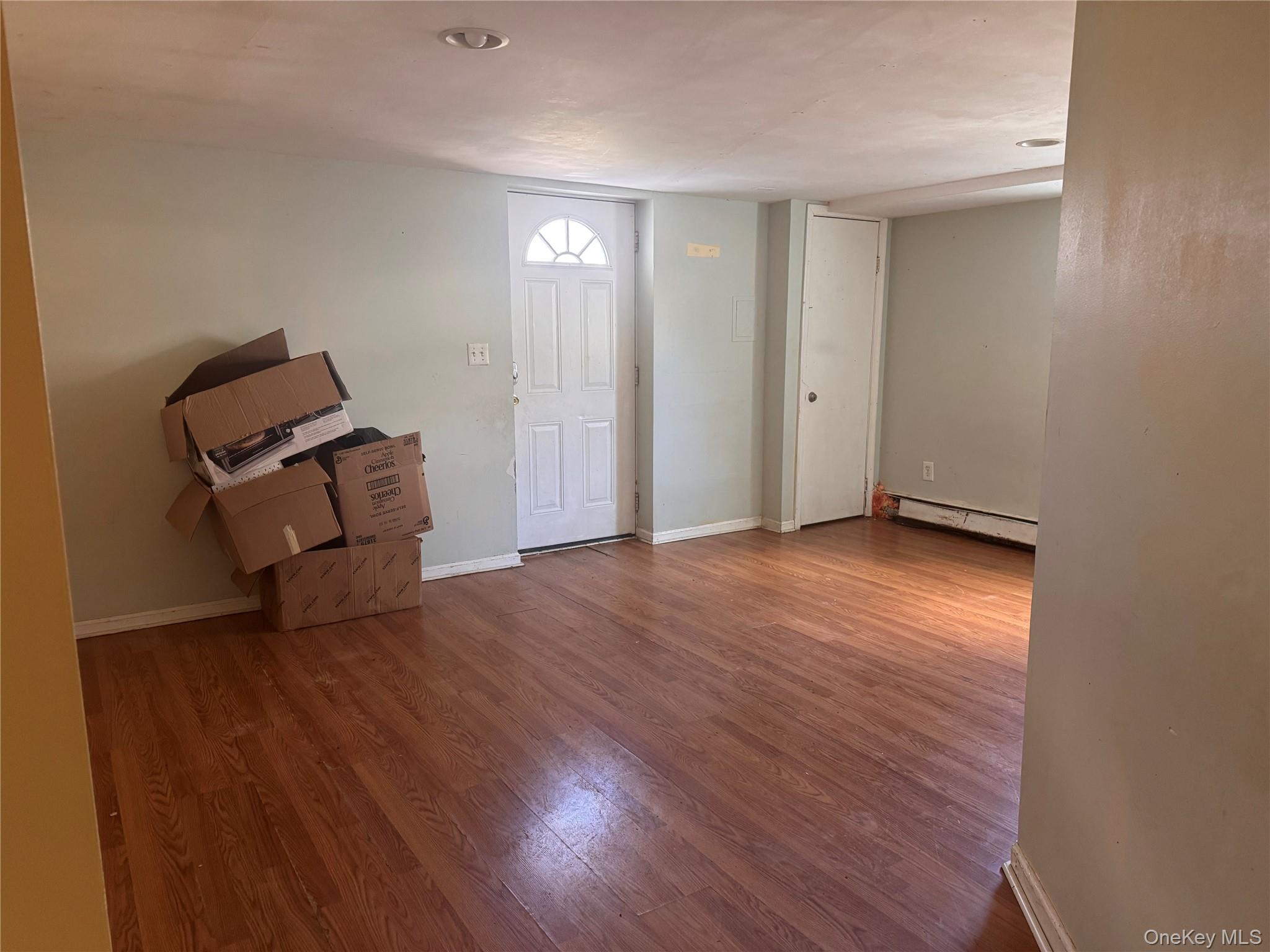 116 Williams Avenue, Unit 101 Spring Valley, NY 10977 - Photo 17 of 23 an empty room with wooden floor and windows