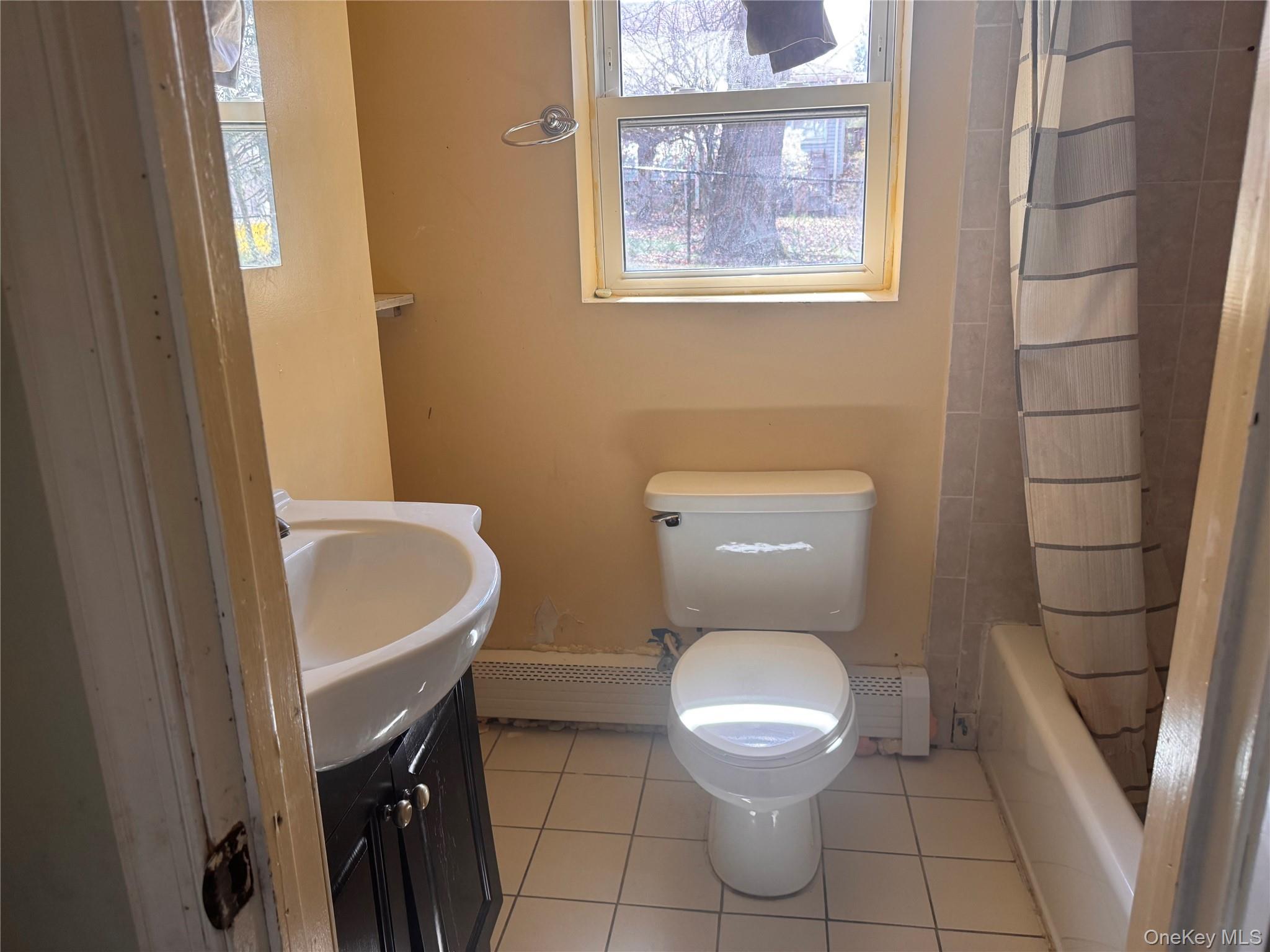 116 Williams Avenue, Unit 101 Spring Valley, NY 10977 - Photo 20 of 23 a white toilet sitting next to a bathroom sink