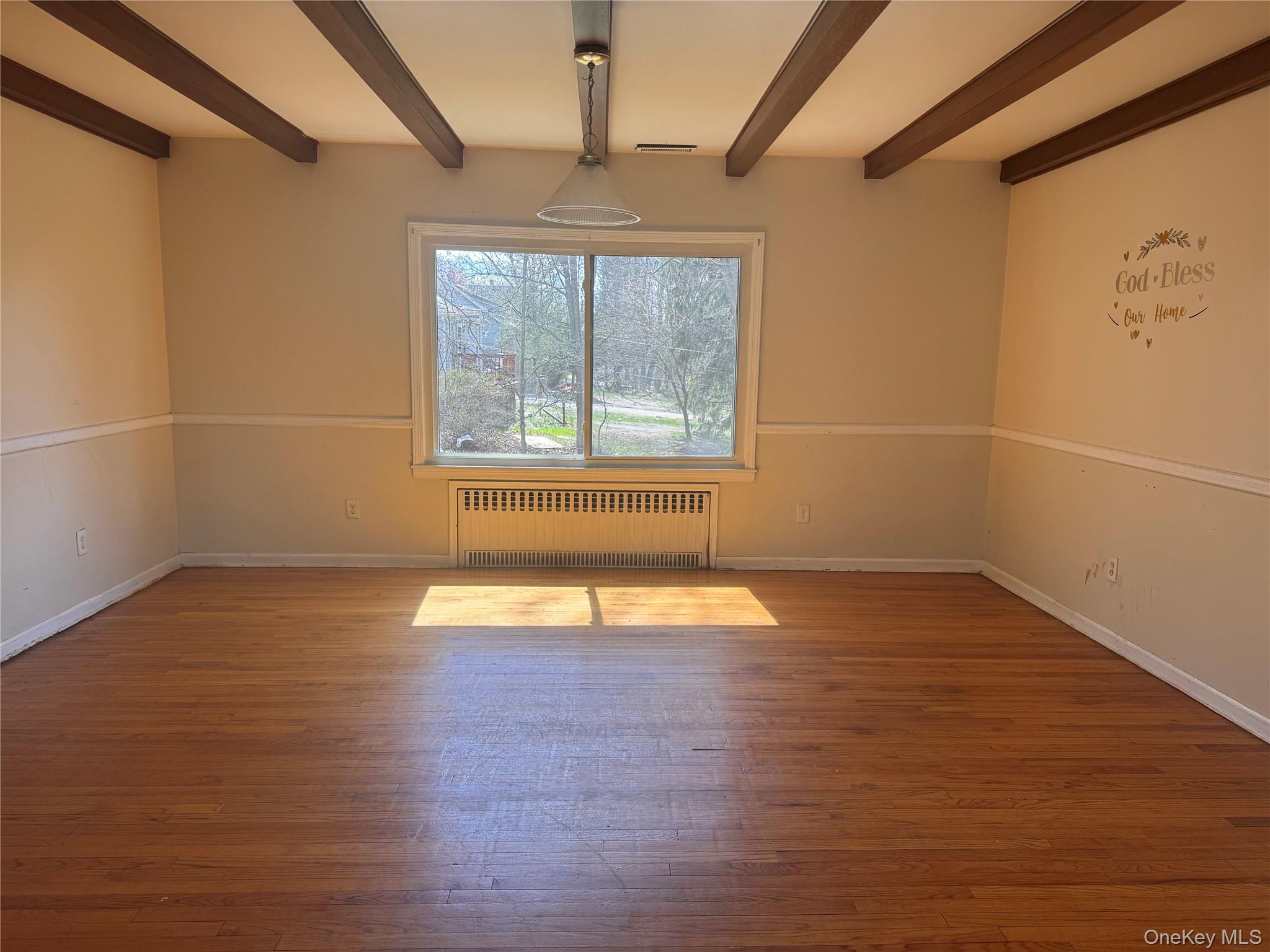 116 Williams Avenue, Unit 101 Spring Valley, NY 10977 - Photo 5 of 23 an empty room with wooden floor and windows