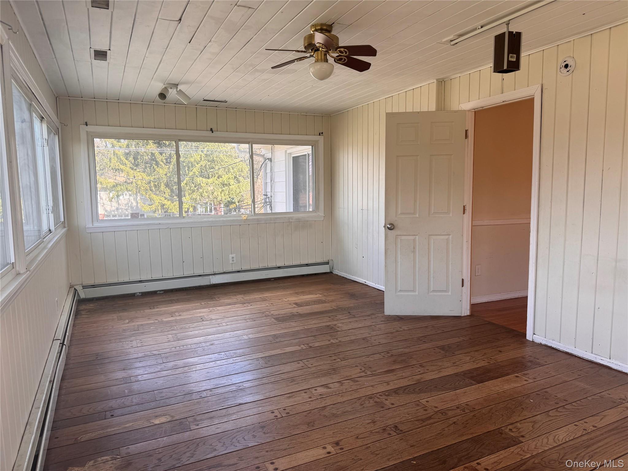 116 Williams Avenue, Unit 101 Spring Valley, NY 10977 - Photo 7 of 23 a view of an empty room with wooden floor and a window