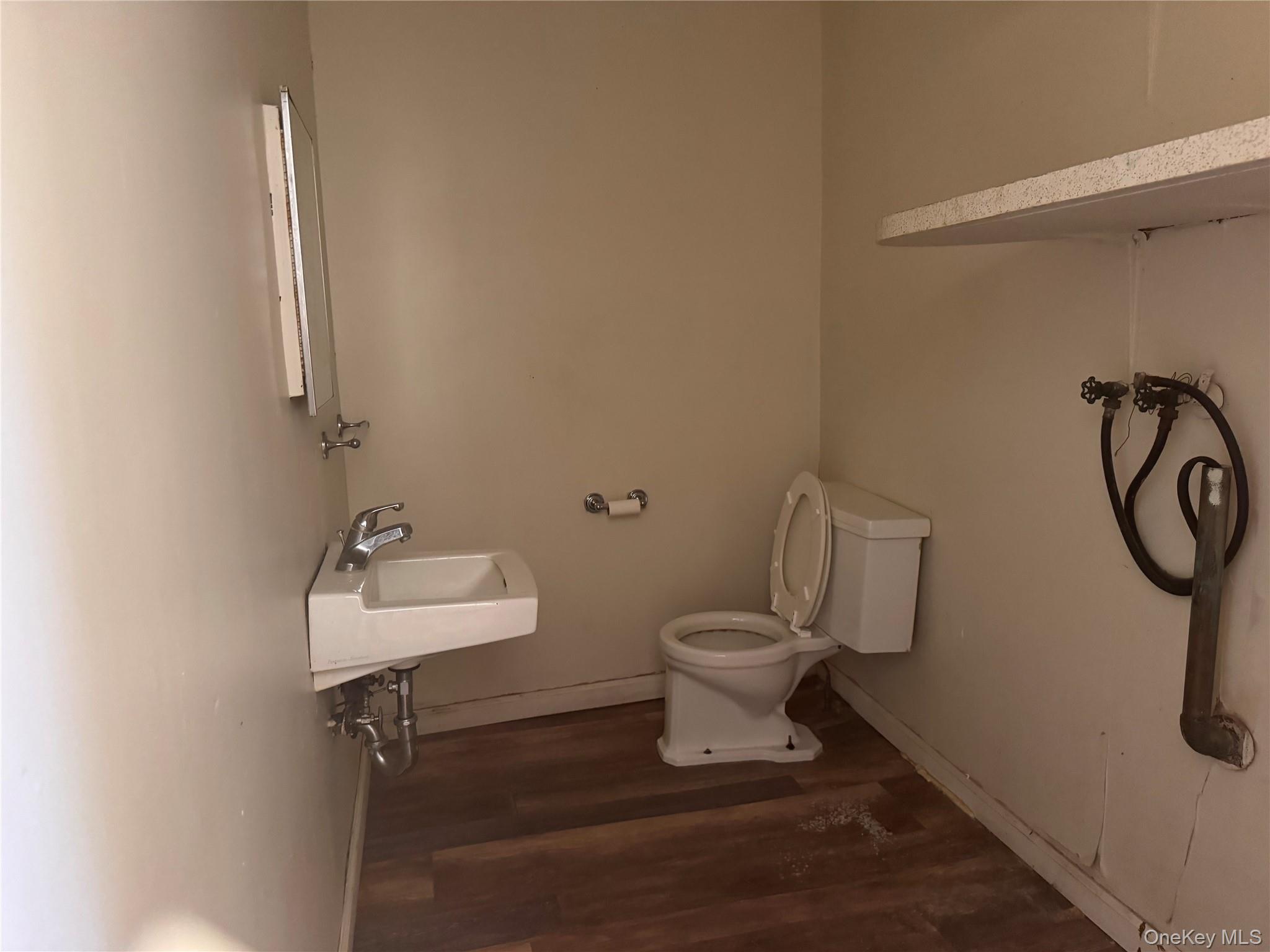 116 Williams Avenue, Unit 101 Spring Valley, NY 10977 - Photo 10 of 23 a bathroom with a toilet sink and mirror