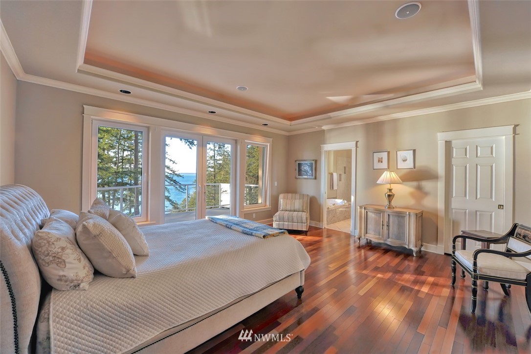 732 Fieldston Road Bellingham, WA 98225 - Photo 11 of 25 a spacious bedroom with a bed a table and large window