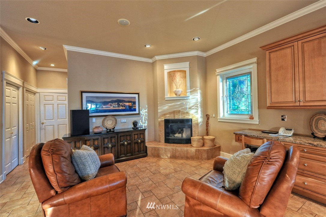 732 Fieldston Road Bellingham, WA 98225 - Photo 8 of 25 a living room with furniture flat screen tv and a fireplace