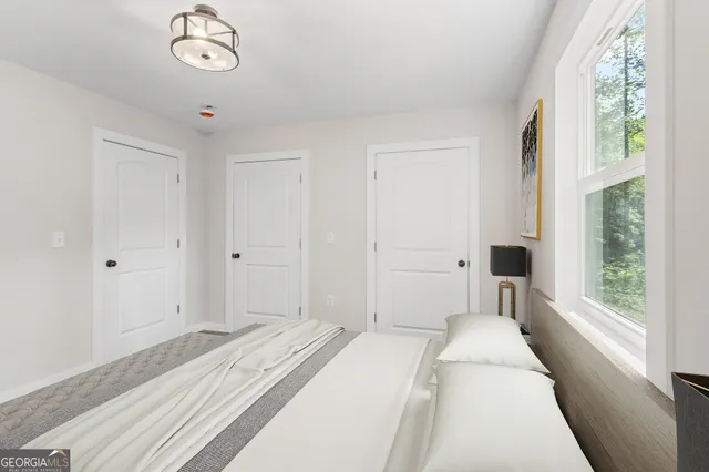 a bedroom with a bed and a window