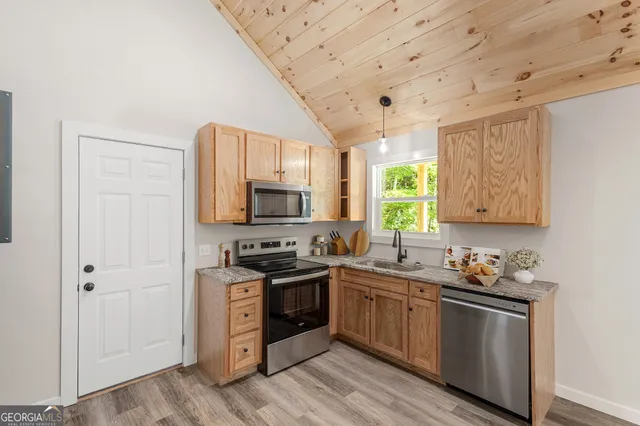 a kitchen with stainless steel appliances a stove sink and refrigerator