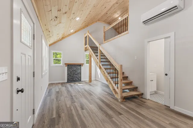 a view of a hallway with wooden floor and staircase