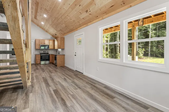 a view of a kitchen with furniture and windows