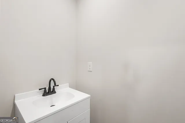 a bathroom with a sink a mirror and vanity