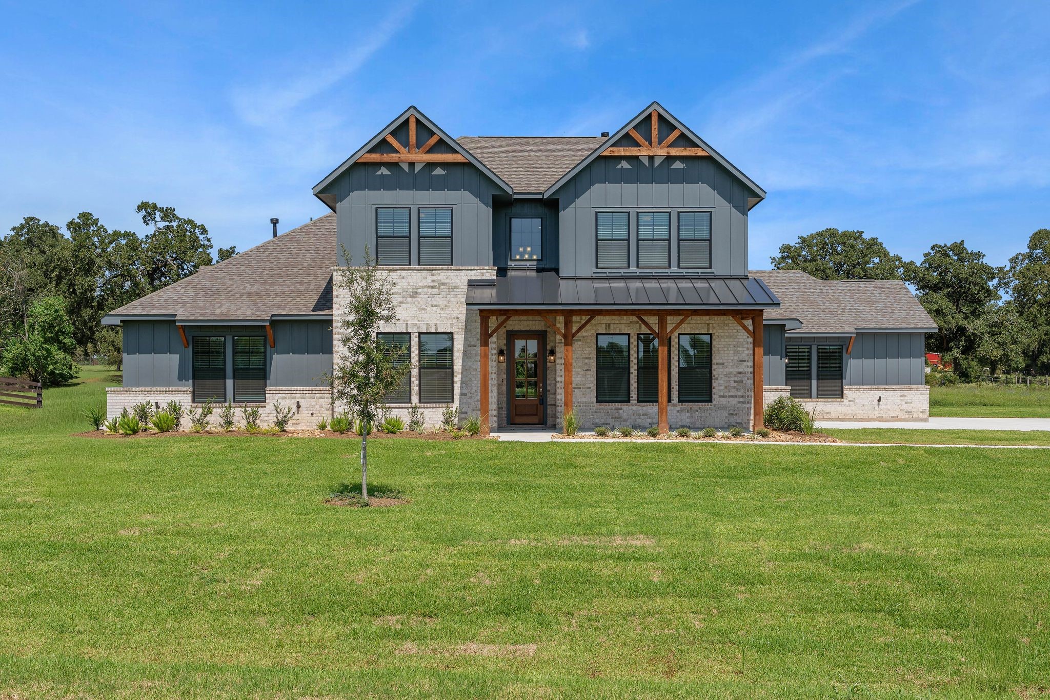 Lot 13 Homestead Hill Road New Waverly, TX 77358 - Photo 3 of 10 a front view of a house with a garden