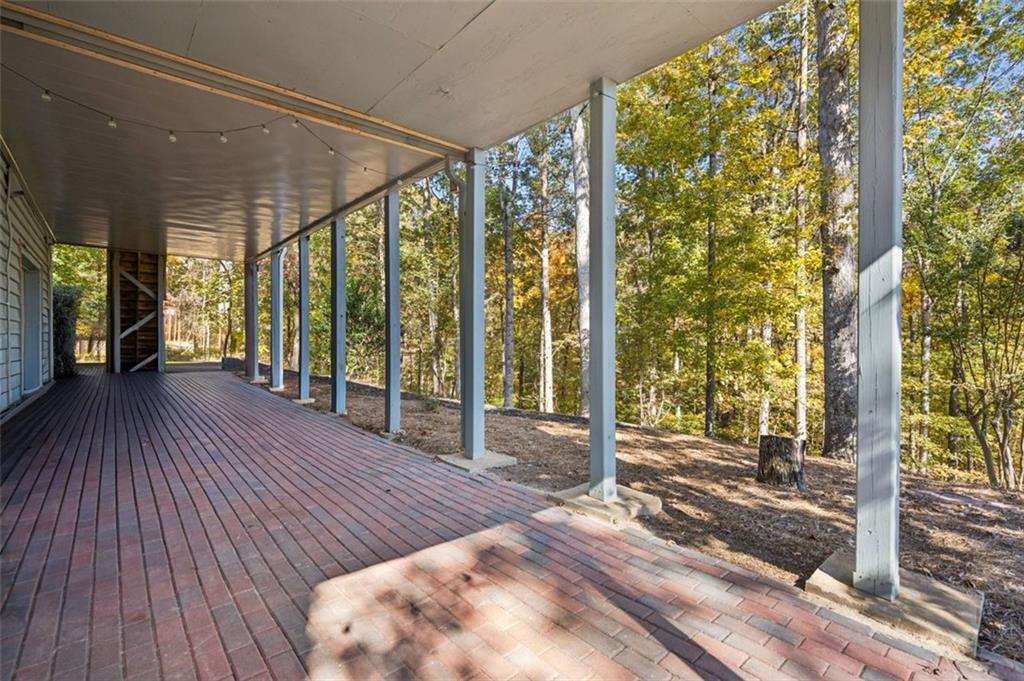 1173 Antioch Campground Road Gainesville, GA 30506 - Photo 17 of 23 a view of a room with floor to ceiling window and wooden floor