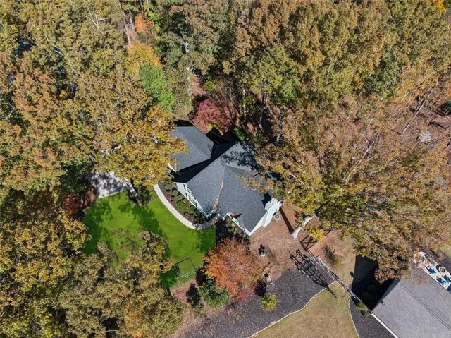an aerial view of a house with a yard