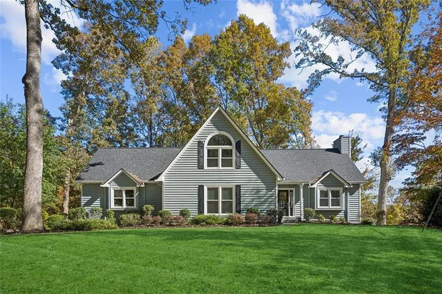 a front view of a house with a garden
