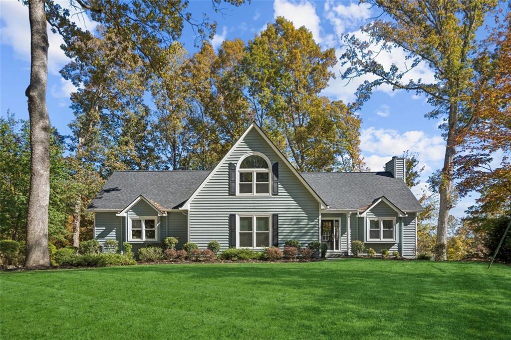 1173 Antioch Campground Road Gainesville, GA 30506 - Photo 2 of 23 a front view of a house with a garden