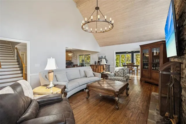 a living room with furniture chandelier and a table