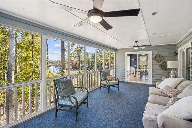a living room with furniture and a floor to ceiling window