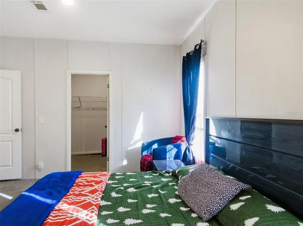 a bedroom with a bed and a dresser in it