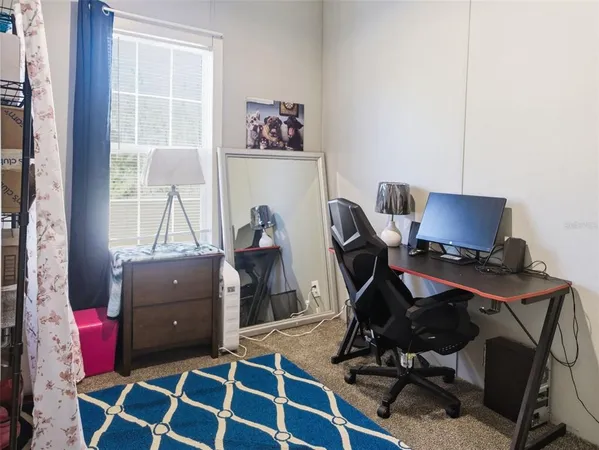 a view of a workspace with furniture and wooden floor